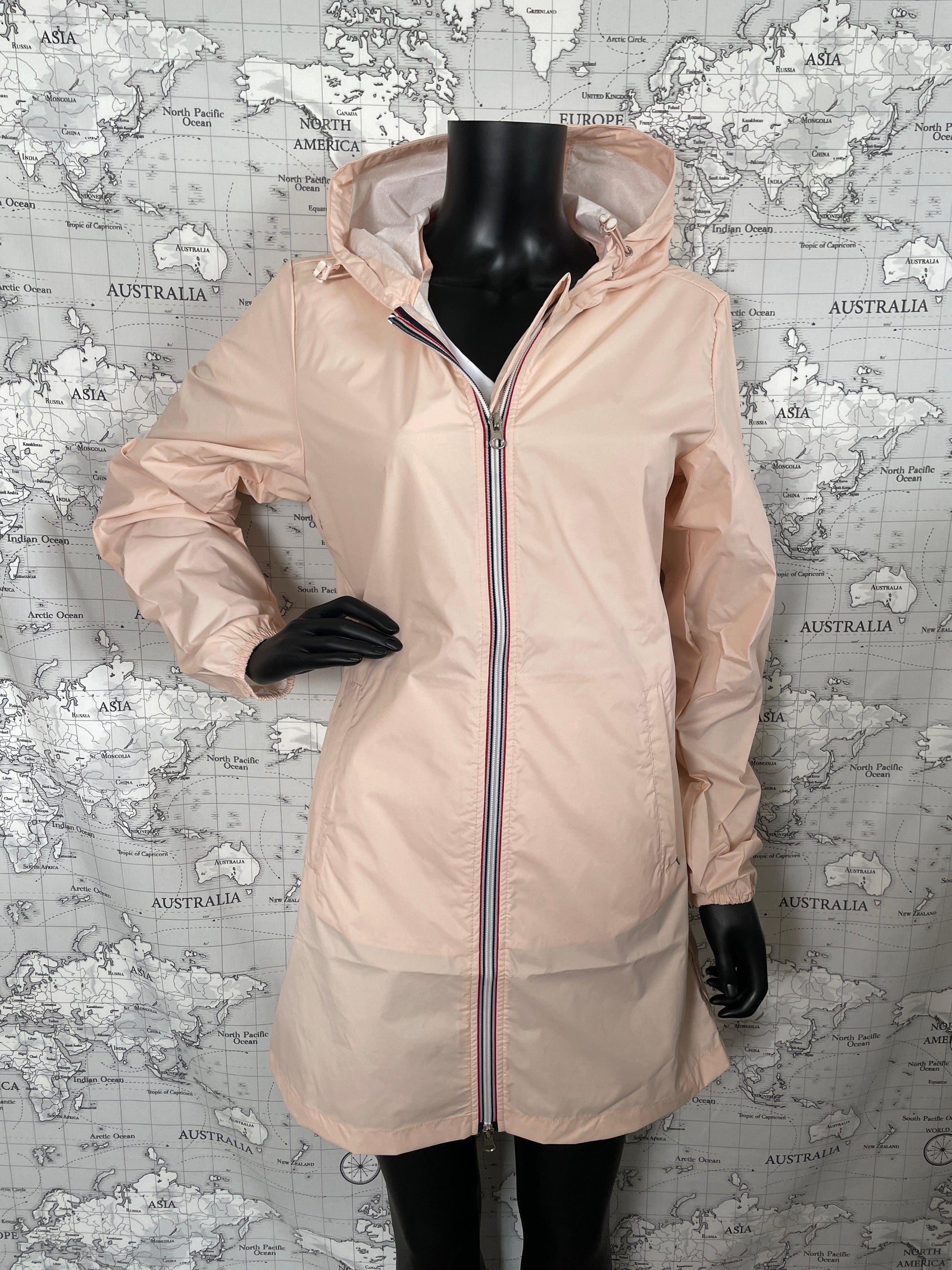 Laura Jo nude pink long raincoat on mannequin, Le Petit Placard, world map backdrop