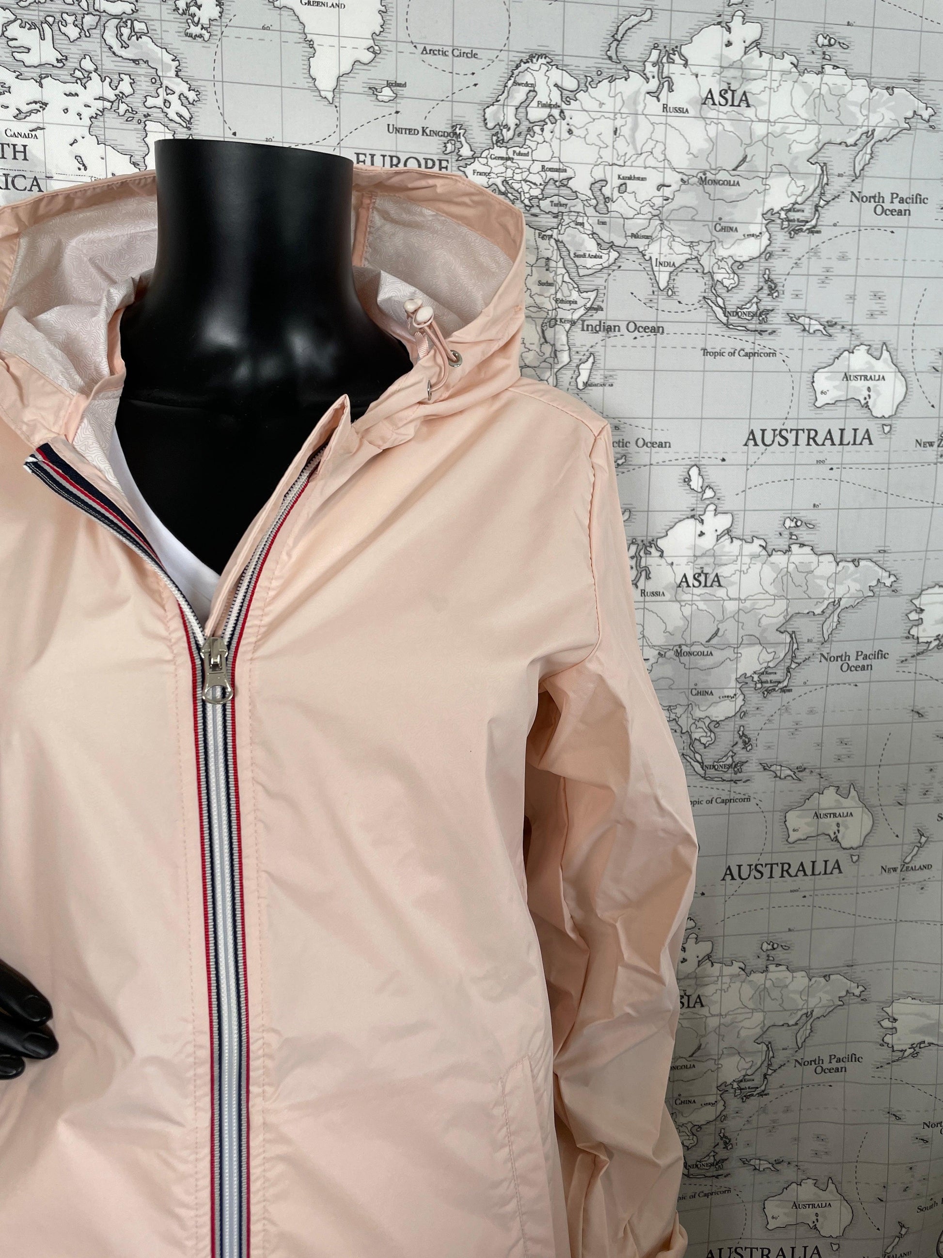 Laura Jo nude pink long raincoat on mannequin, Le Petit Placard, world map background