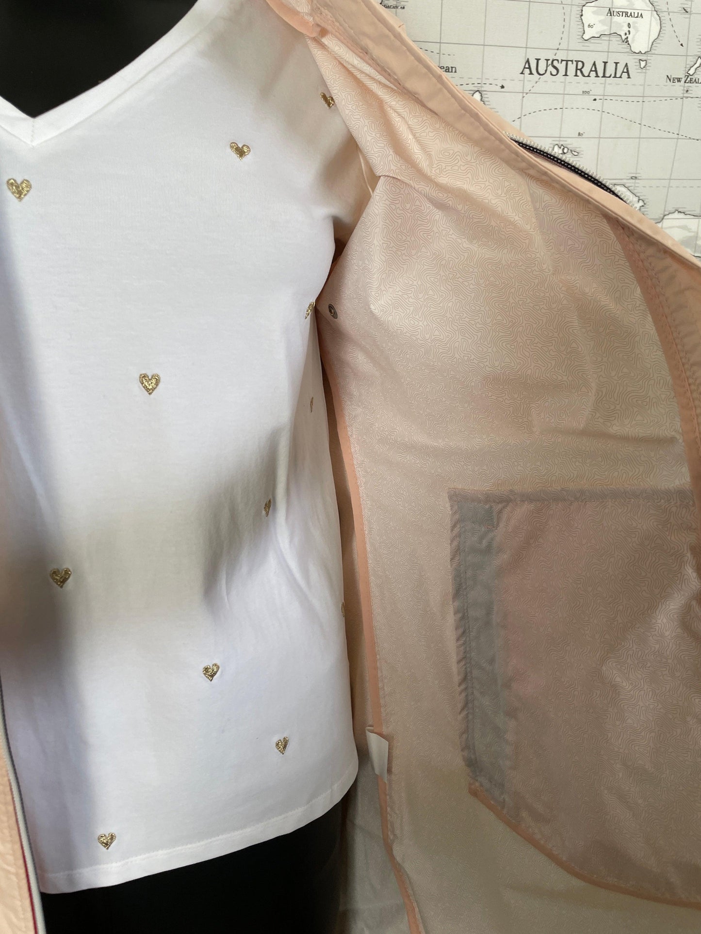 Laura Jo nude pink long raincoat interior detail with white shirt and gold heart accents