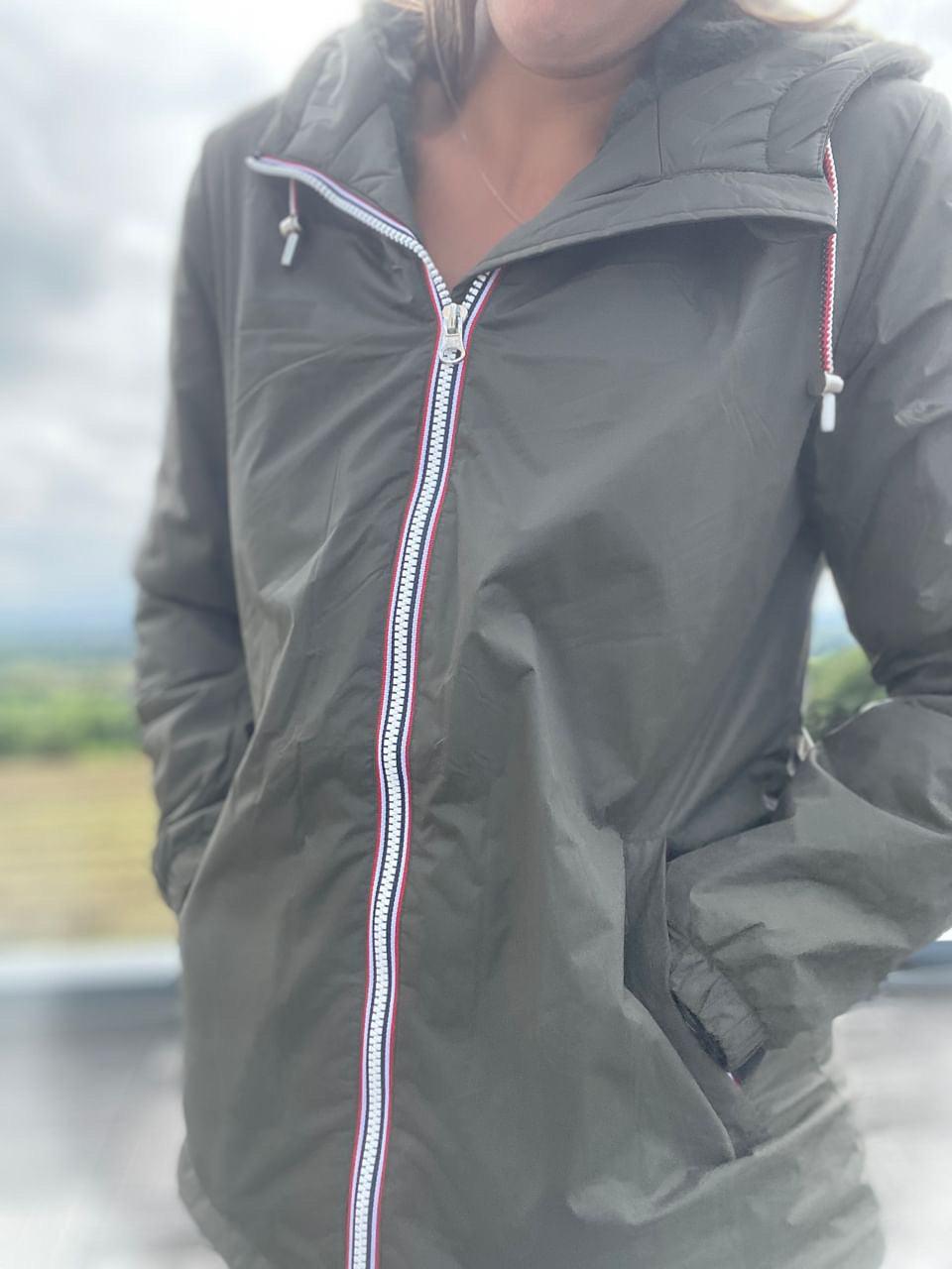 Woman wearing a Laura Jo raincoat outdoors, hands in pockets, zippered jacket, Le Petit Placard