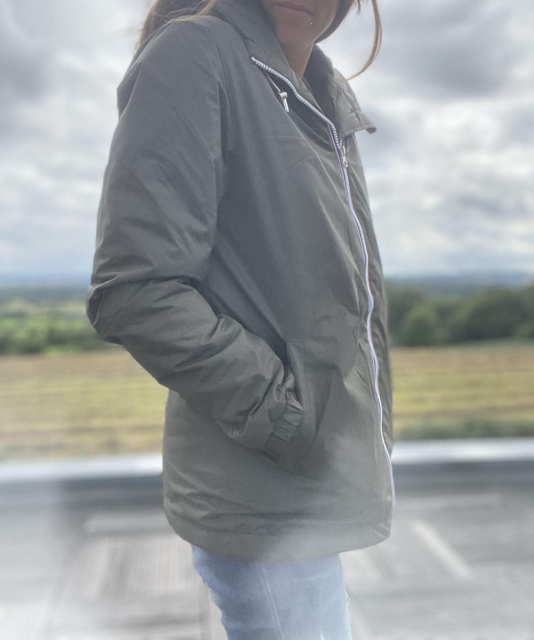 Woman wearing Laura Jo green rain jacket outdoors, Le Petit Placard fashion