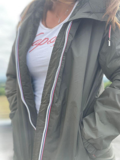 Woman wearing khaki Laura Jo raincoat with zipper detail from Le Petit Placard