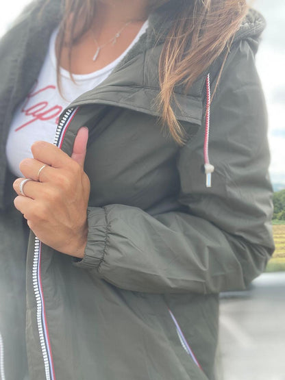 Woman wearing a Laura Jo waterproof jacket in khaki, outdoor scene, Le Petit Placard