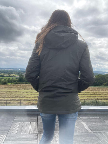 Woman in Laura Jo raincoat and jeans overlooking countryside, Le Petit Placard fashion