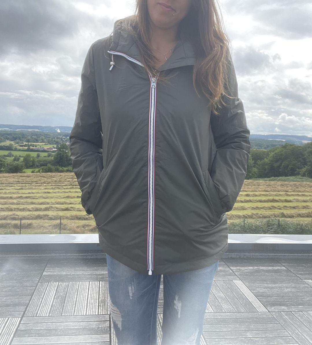 Woman wearing Laura Jo waterproof jacket and ripped jeans outdoors, Le Petit Placard collection