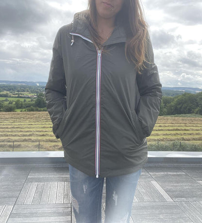 Woman wearing Laura Jo waterproof jacket and ripped jeans outdoors, Le Petit Placard collection