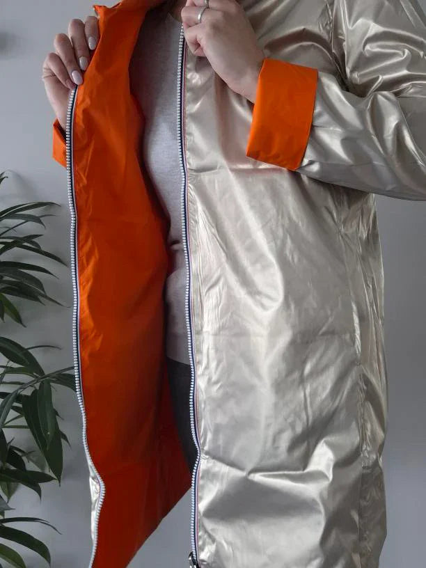 Woman wearing Laura Jo metallic raincoat with orange lining, Le Petit Placard fashion