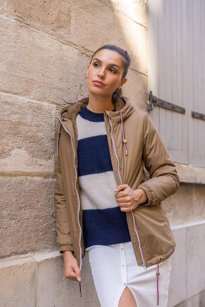 Woman wearing a camel Laura Jo mid-length raincoat with faux fur and tricolor drawstrings