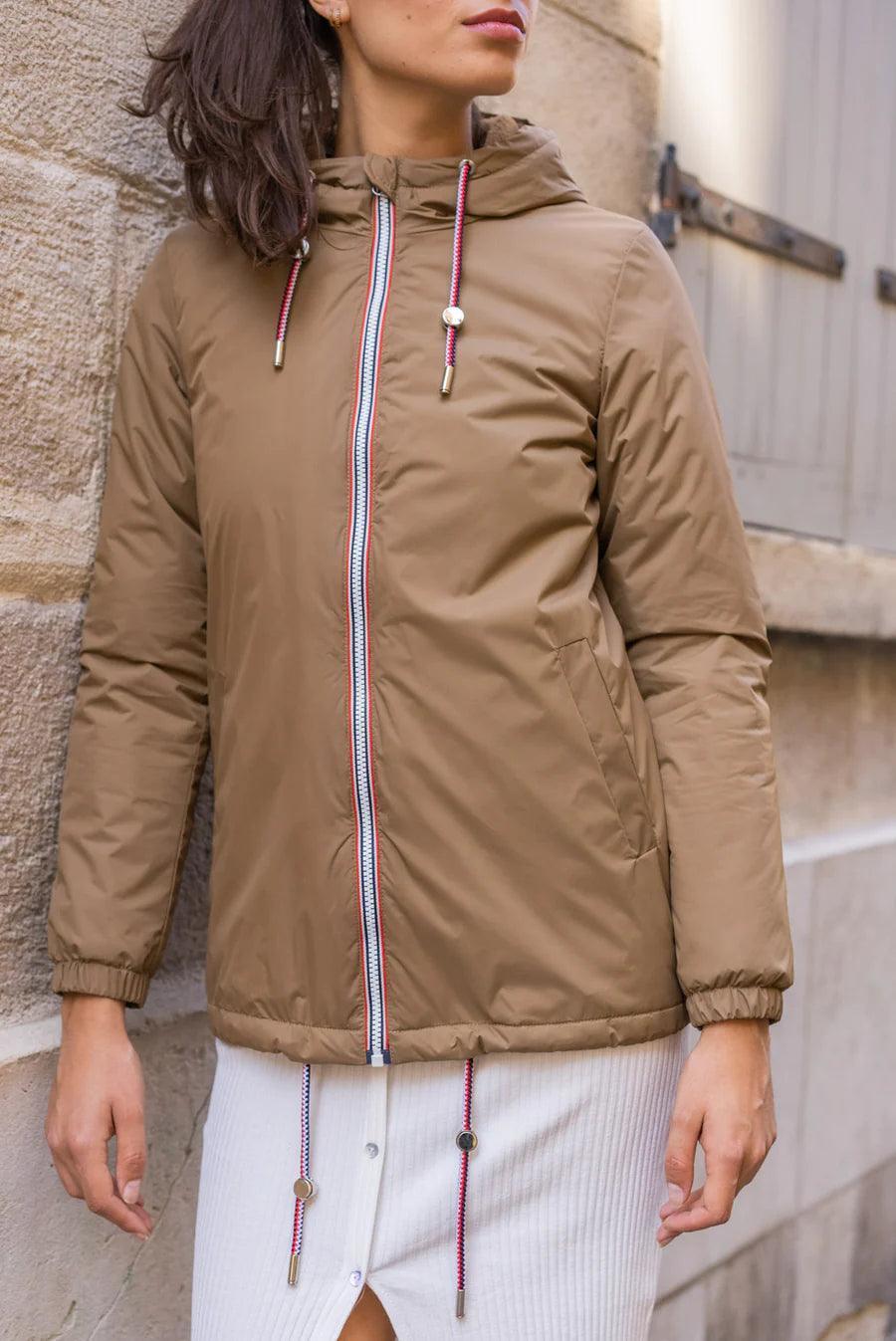 Woman wearing camel Laura Jo waterproof mid-length jacket with tricolor cord, Le Petit Placard