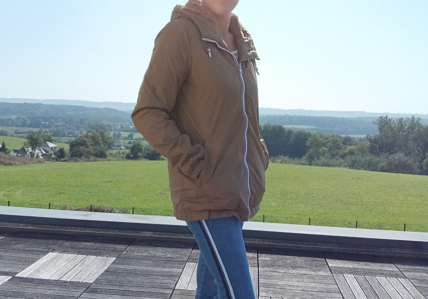 Woman wearing camel Laura Jo raincoat outdoors, Le Petit Placard fashion