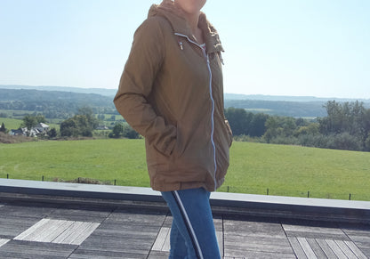 Woman wearing camel Laura Jo raincoat outdoors, Le Petit Placard fashion