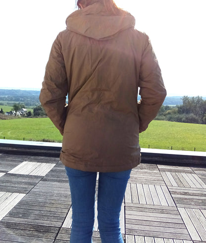 Woman wearing camel Laura Jo raincoat and blue jeans outdoors, Le Petit Placard fashion