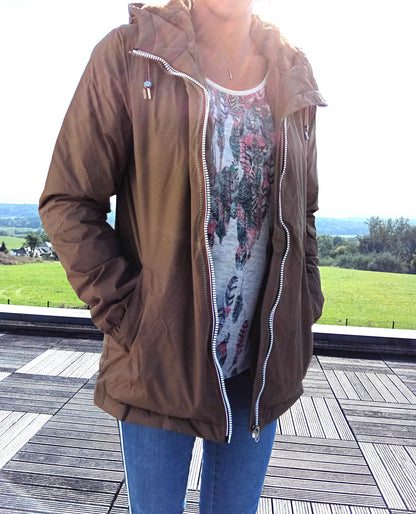 Woman wearing brown Laura Jo raincoat with hood and jeans outdoors, Le Petit Placard fashion