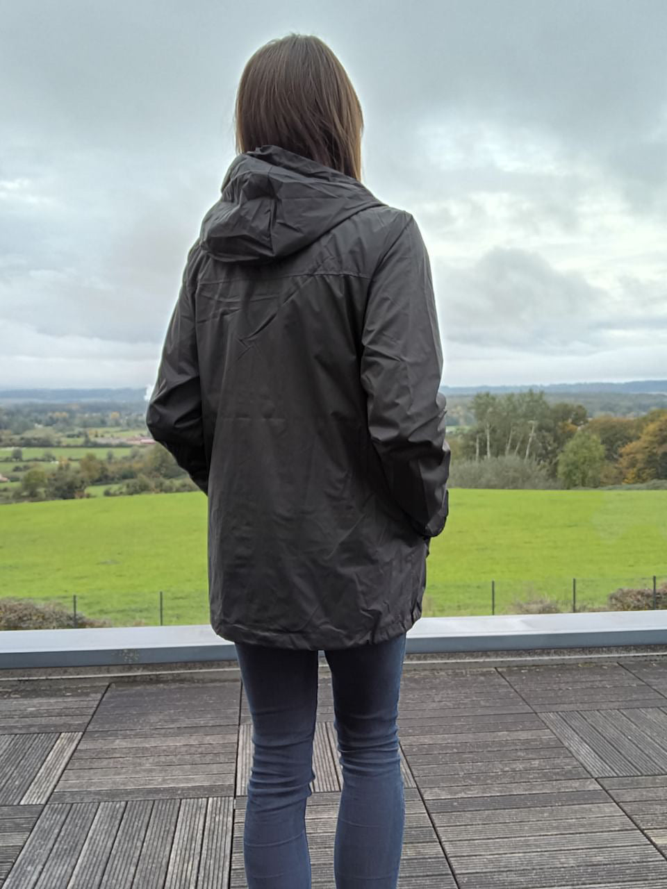 Woman wearing Laura Jo raincoat outdoors, Le Petit Placard fashion, countryside view