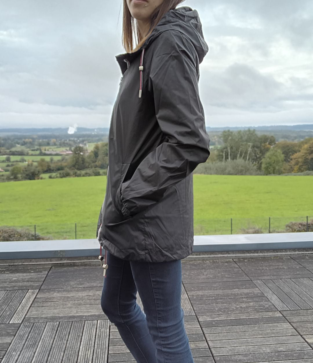Woman wearing Laura Jo black mid-length raincoat outdoors, Le Petit Placard fashion