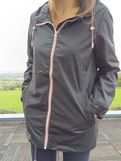 Black Laura Jo mid-season raincoat with hood, outdoor setting, Le Petit Placard