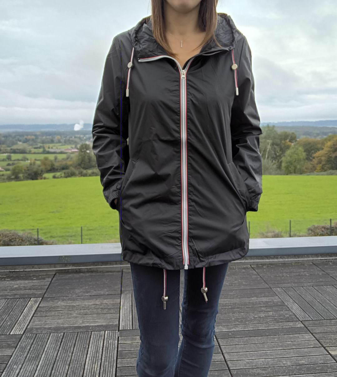 Woman wearing black Laura Jo mid-length raincoat outdoors, Le Petit Placard fashion