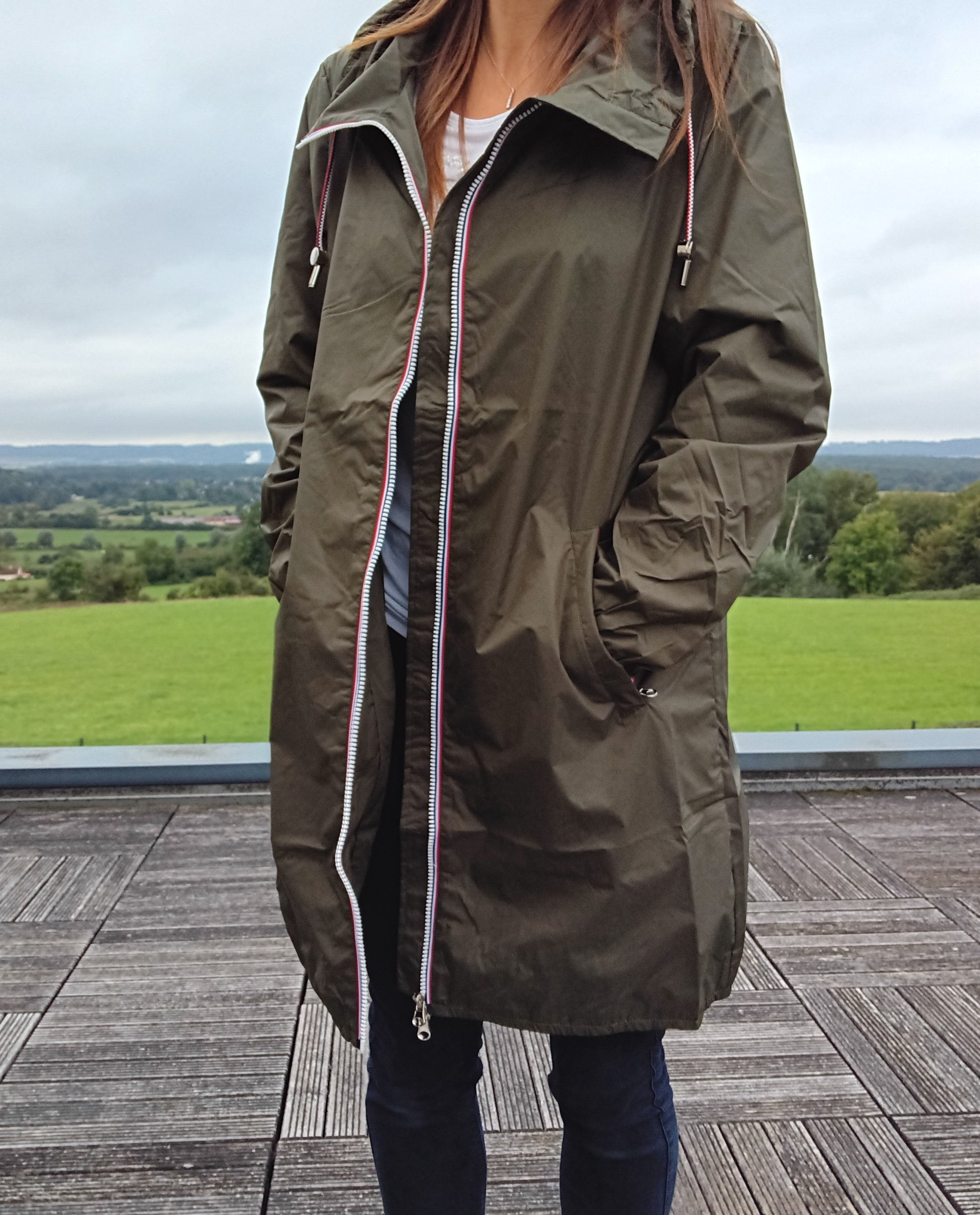 Woman wearing Laura Jo khaki raincoat, outdoor view, Le Petit Placard fashion accessory