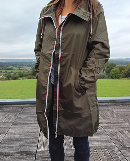 Woman wearing Laura Jo khaki raincoat, outdoor view, Le Petit Placard fashion accessory