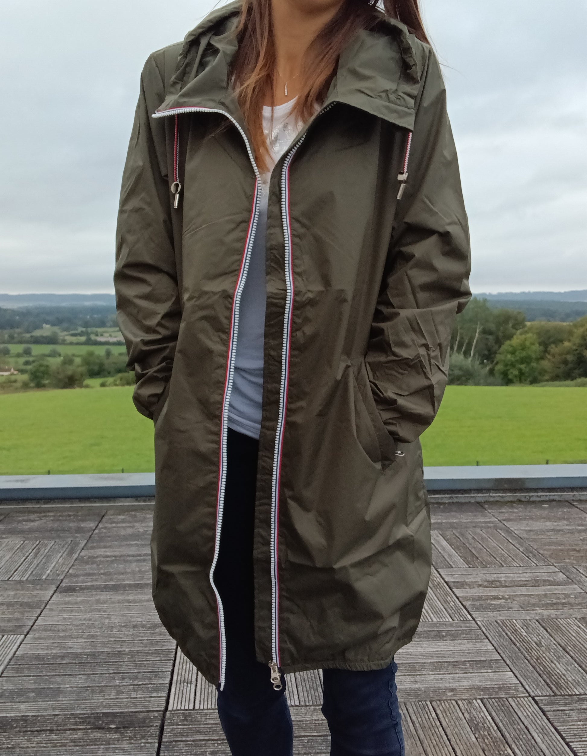Woman wearing khaki Laura Jo raincoat outdoors, Le Petit Placard fashion collection