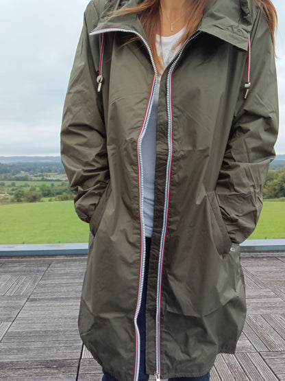 Woman wearing khaki Laura Jo raincoat from Le Petit Placard, outdoor terrace view