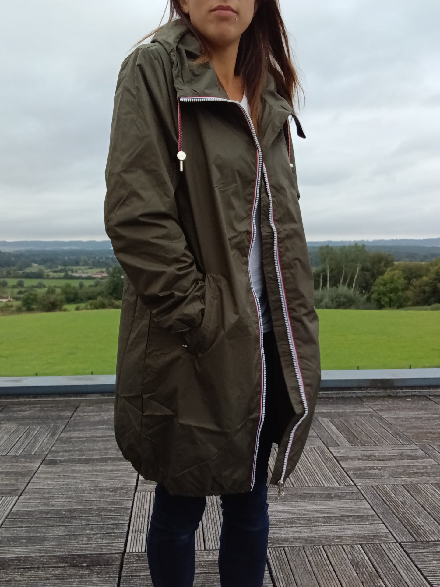 Woman wearing an olive green Laura Jo raincoat outdoors, Le Petit Placard fashion