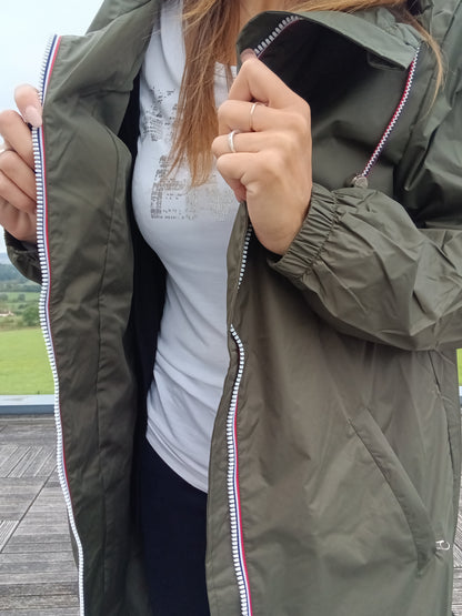 Woman wearing khaki Laura Jo raincoat, white shirt, trendy outdoor style Le Petit Placard