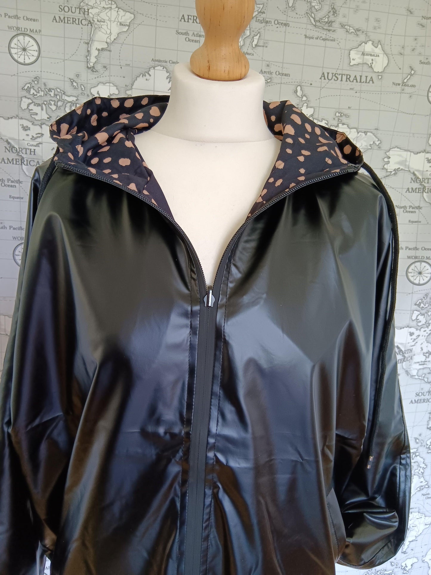 Black reversible waterproof jacket with polka dot hood by Le Petit Placard