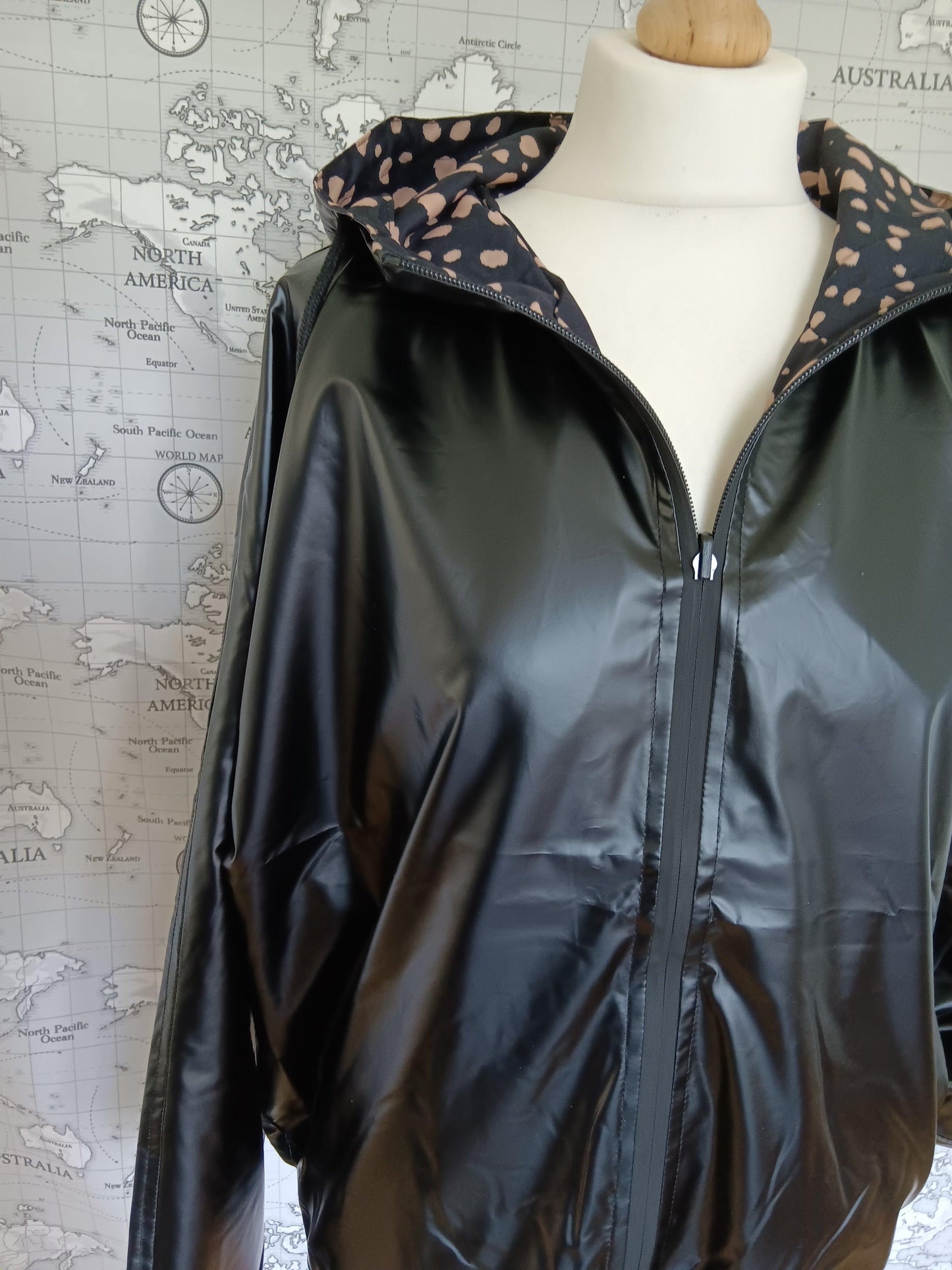 Black reversible raincoat with polka dot lining by Le Petit Placard on mannequin