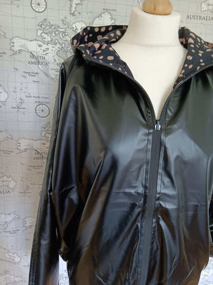 Black reversible raincoat with polka dot lining by Le Petit Placard on mannequin