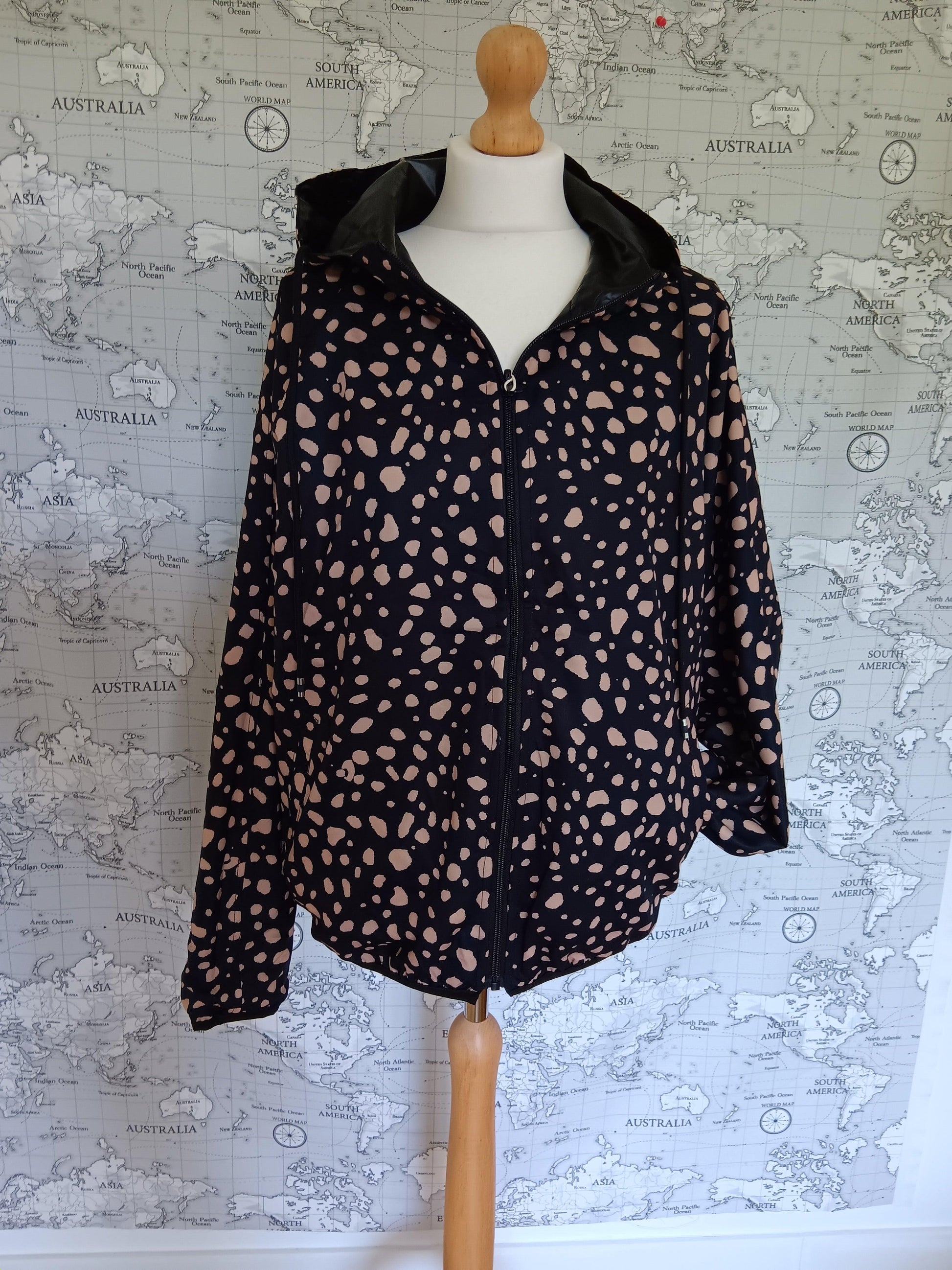 Black reversible rain jacket with beige spots on a mannequin, Le Petit Placard collection
