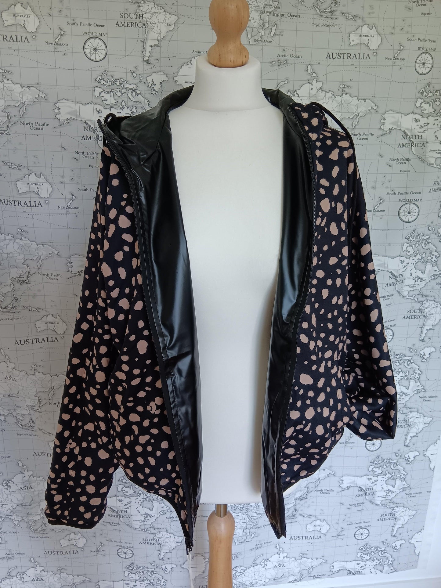 Reversible black raincoat with pink polka dots from Le Petit Placard on mannequin