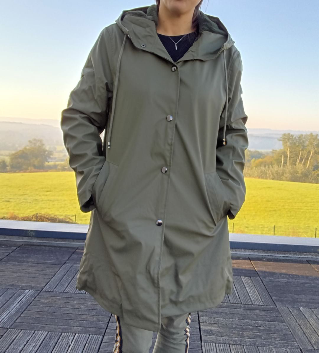Woman wearing a khaki Laura Jo raincoat outdoors, Le Petit Placard trendy outerwear