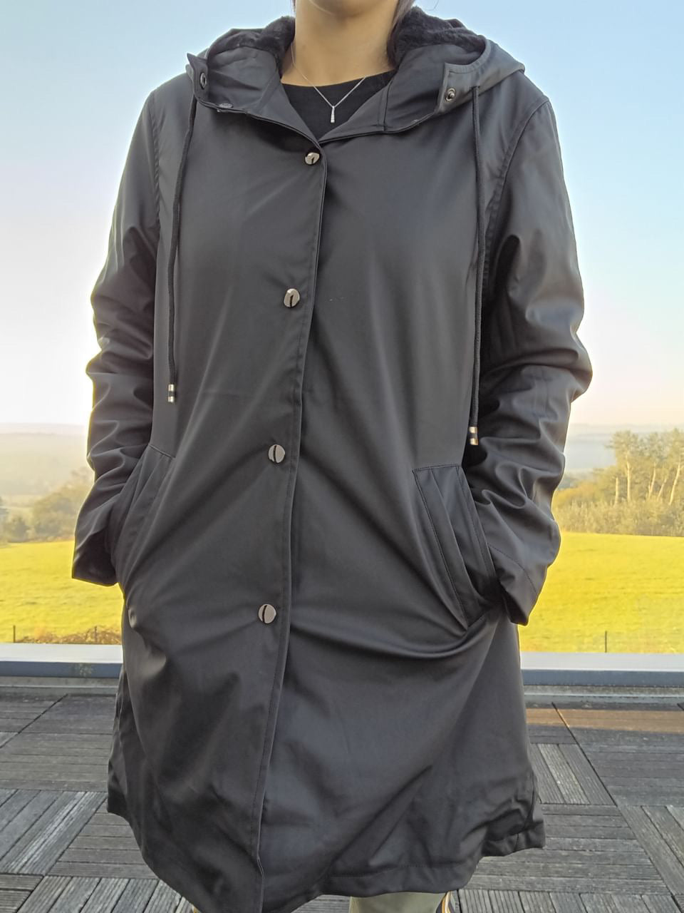 Woman wearing a black Laura Jo raincoat outdoors, Le Petit Placard fashion