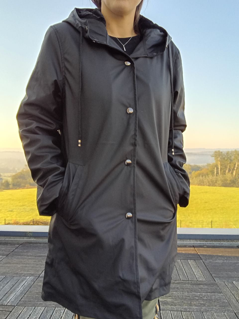 Woman wearing a black Laura Jo raincoat outdoors, Le Petit Placard fashion