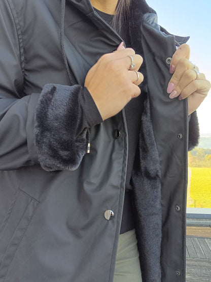 Black long waterproof Laura Jo coat with faux fur lining, worn outdoors, Le Petit Placard