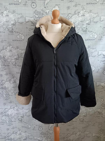 Reversible black and beige faux shearling waterproof jacket on mannequin, Le Petit Placard