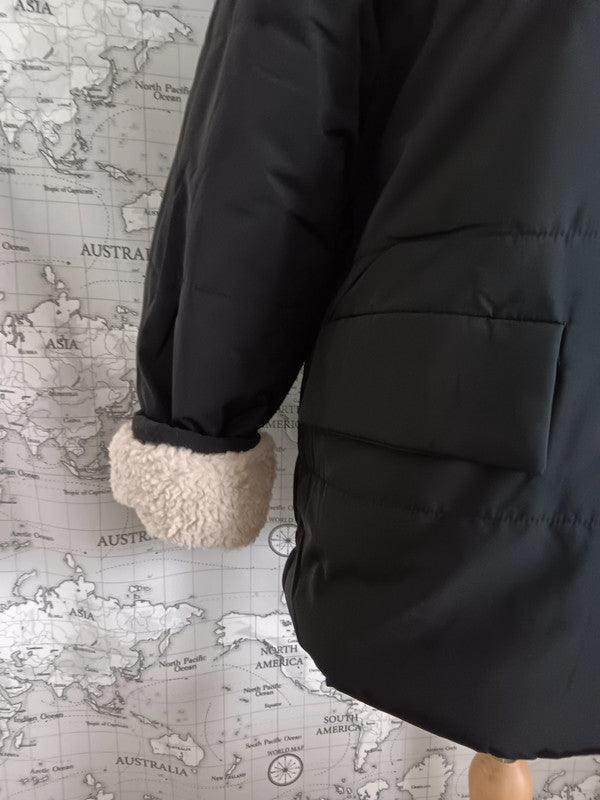 Black reversible waterproof short coat with faux shearling cuff by Le Petit Placard