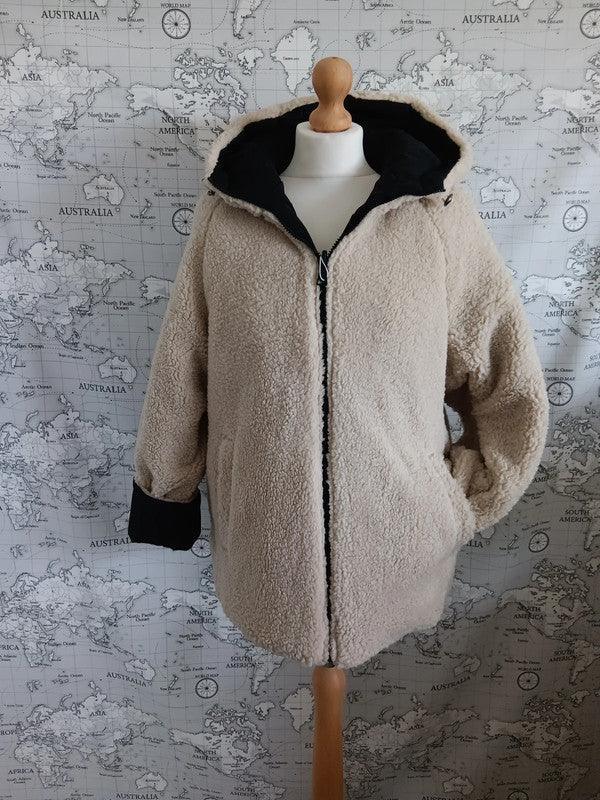 Reversible waterproof faux shearling jacket in beige and black on mannequin, Le Petit Placard