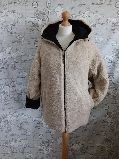 Reversible waterproof faux shearling jacket in beige and black on mannequin, Le Petit Placard