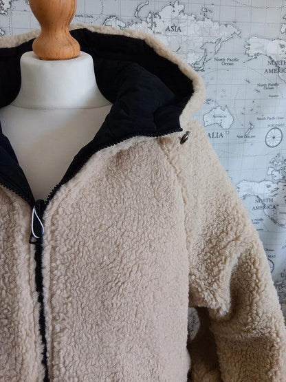Reversible beige faux shearling and black waterproof short coat on mannequin, Le Petit Placard