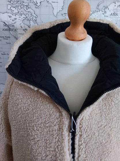Reversible black and beige faux shearling short coat on mannequin, Le Petit Placard.