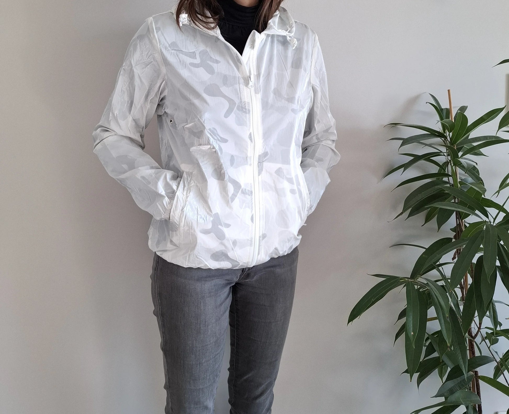 Woman wearing Laura Jo white camouflage rain jacket from Le Petit Placard, casual style