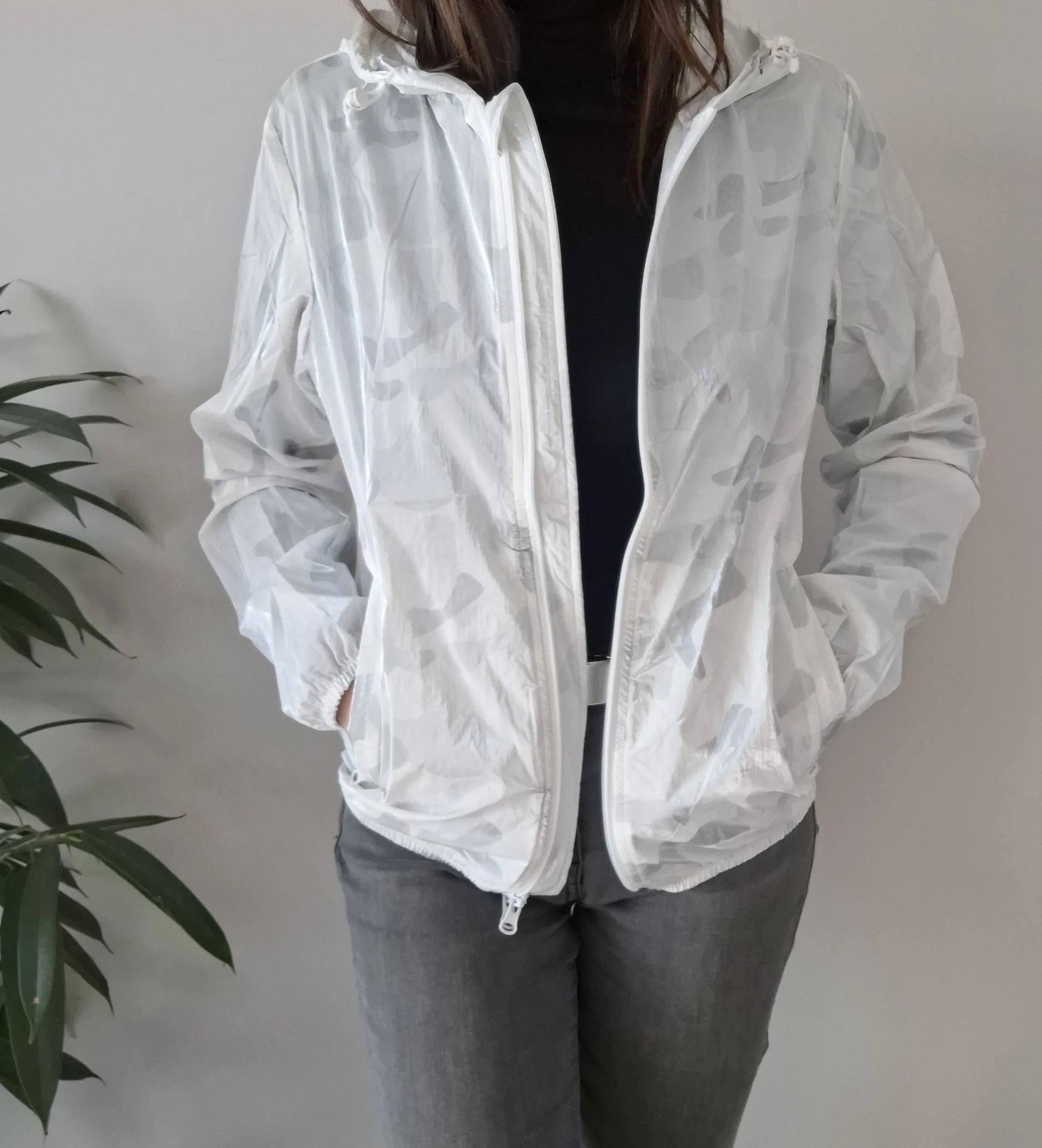 Woman wearing a Laura Jo white camo rain jacket from Le Petit Placard