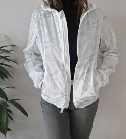 Woman wearing a Laura Jo white camo rain jacket from Le Petit Placard