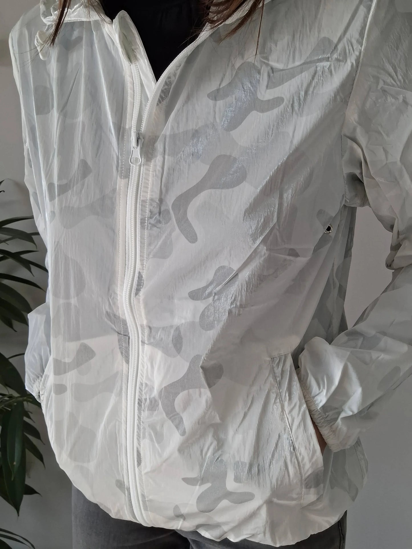 White Laura Jo rain jacket with subtle camo print, featured at Le Petit Placard
