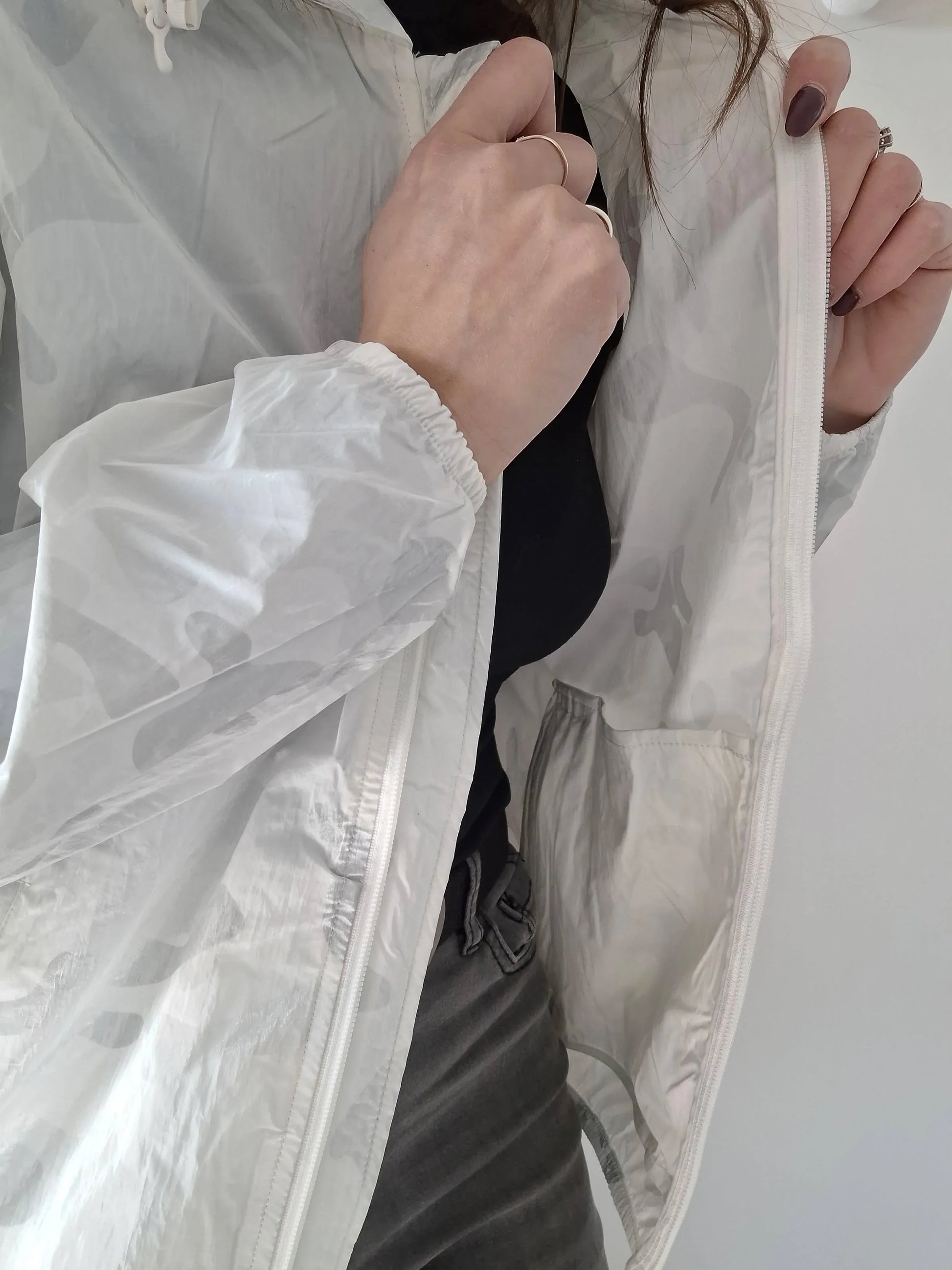 Close-up of a woman wearing a white Laura Jo raincoat, Le Petit Placard fashion