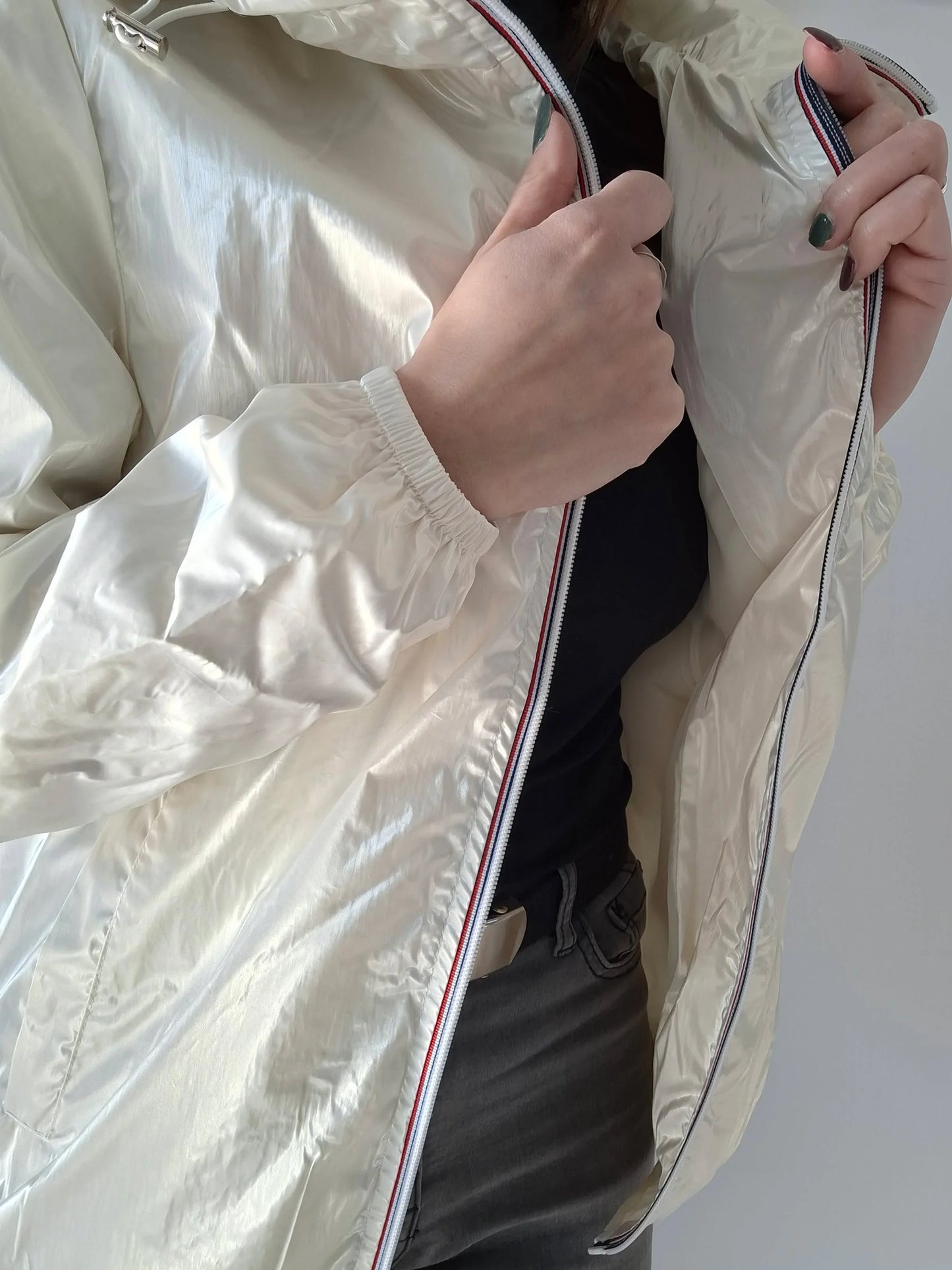 Close-up of person wearing shiny cream Laura Jo raincoat, Le Petit Placard fashion