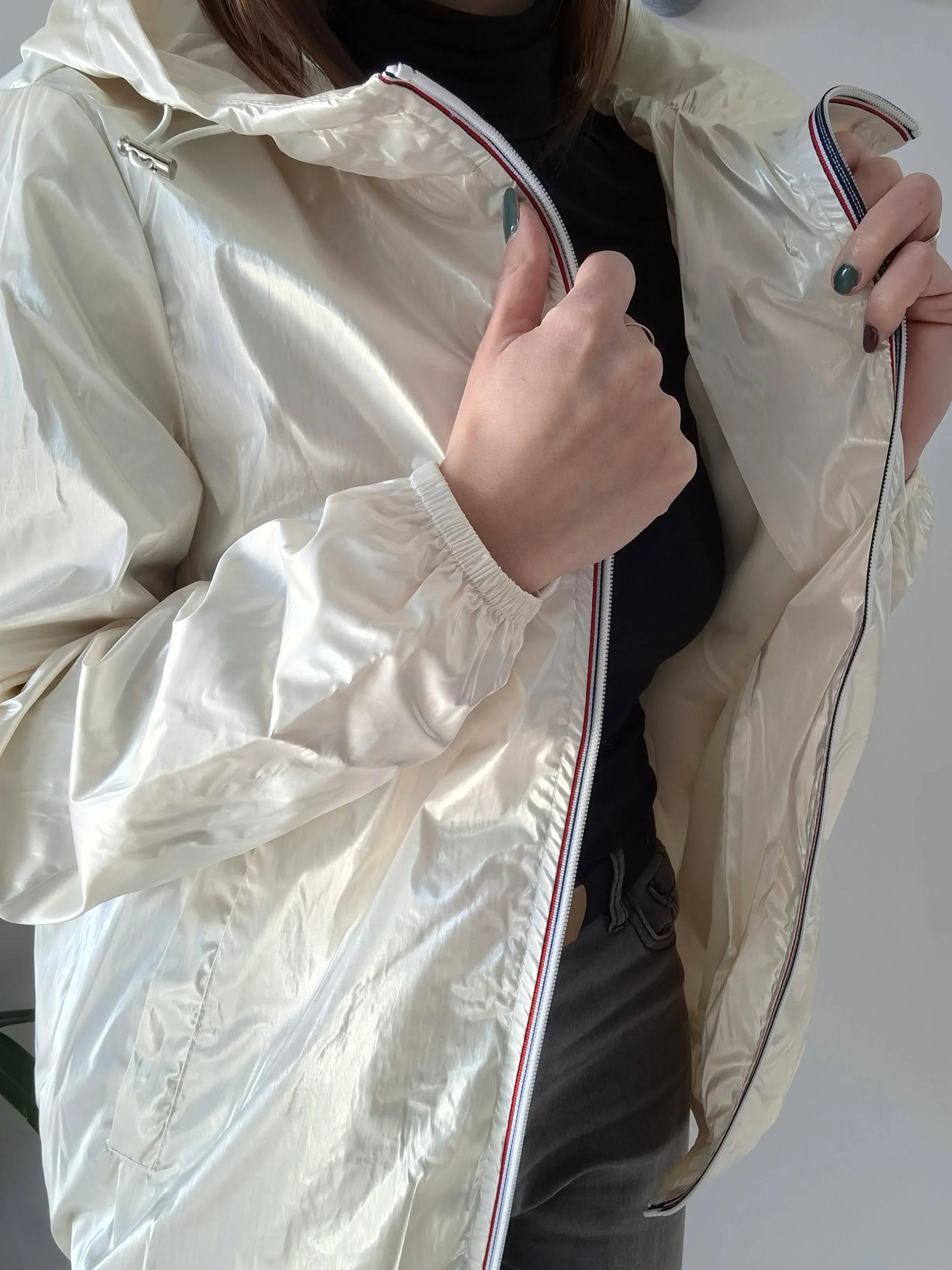 Woman wearing shiny cream Laura Jo raincoat, Le Petit Placard fashion outerwear