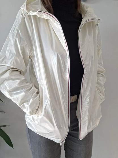 Woman wearing a shiny white Laura Jo raincoat, Le Petit Placard fashion accessory.